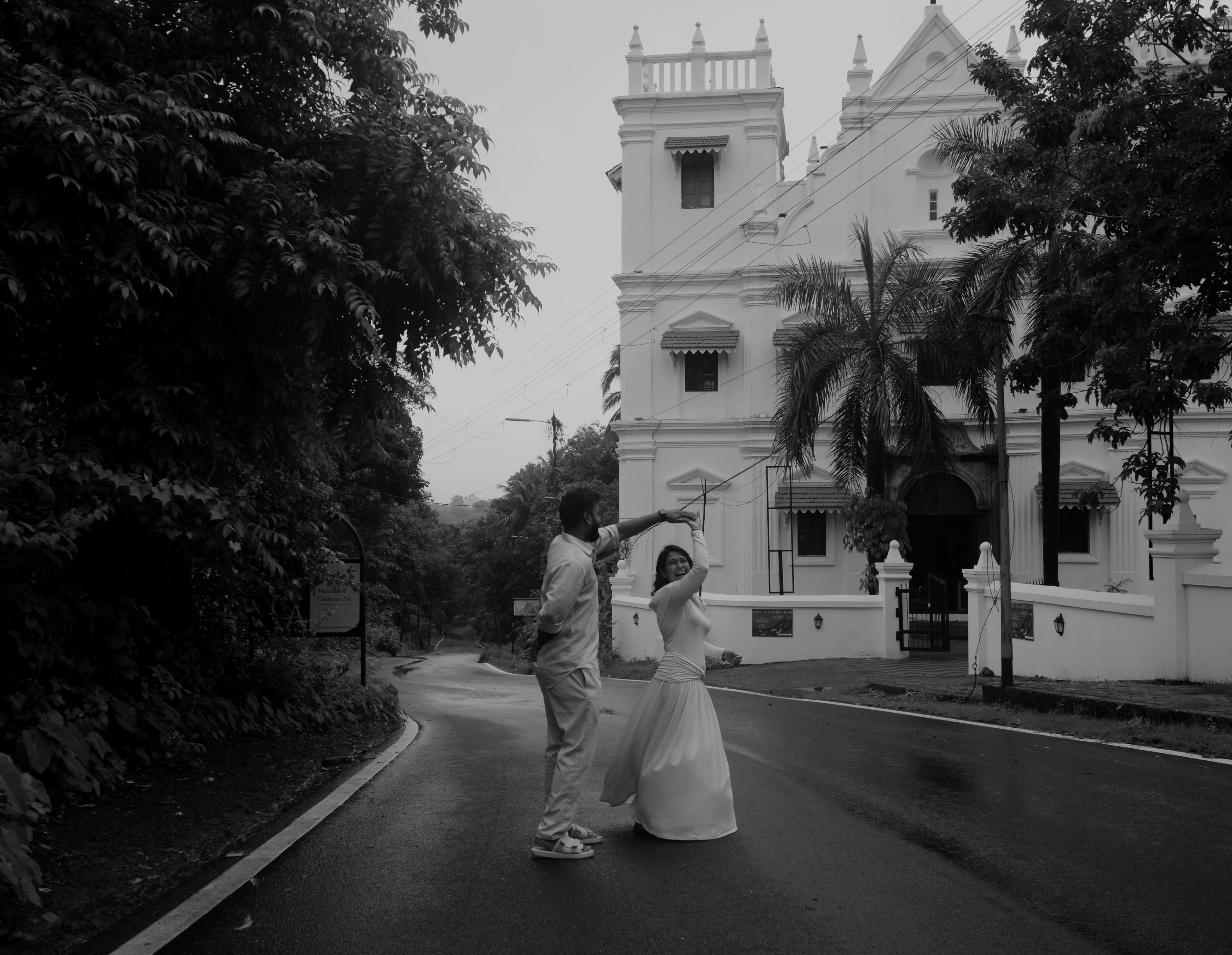 Pratiyush and Nikita dancing in the street outside a church in Goa